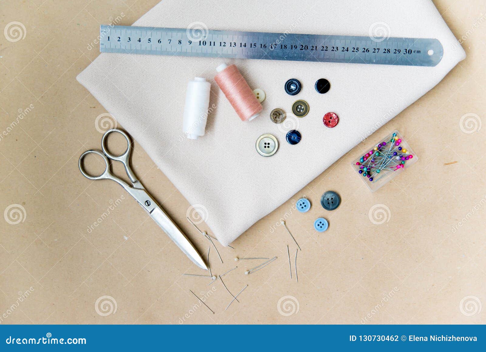 Set of Sewing Tools Scissors, Needles, Buttons, Thread on a Table