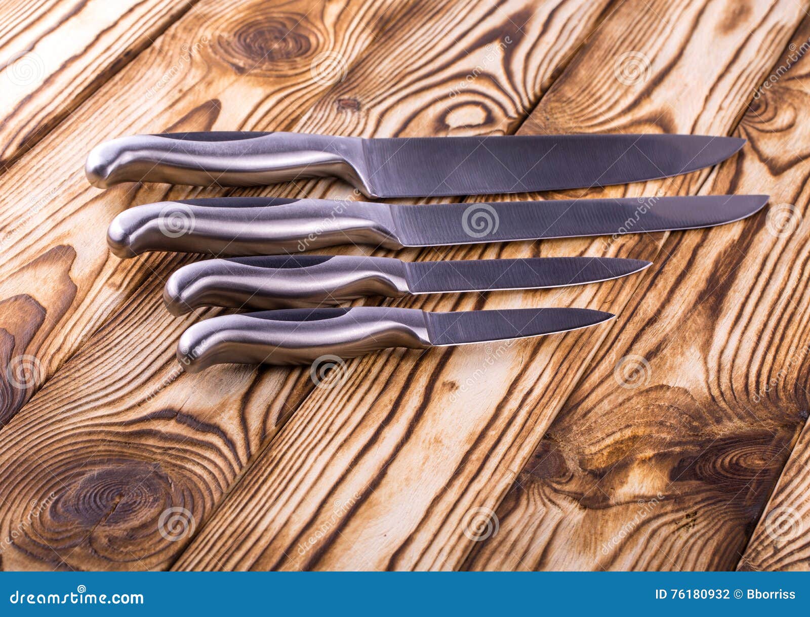 Set of Shiny Metal Kitchen Knives on a Wooden Table Stock Photo Image