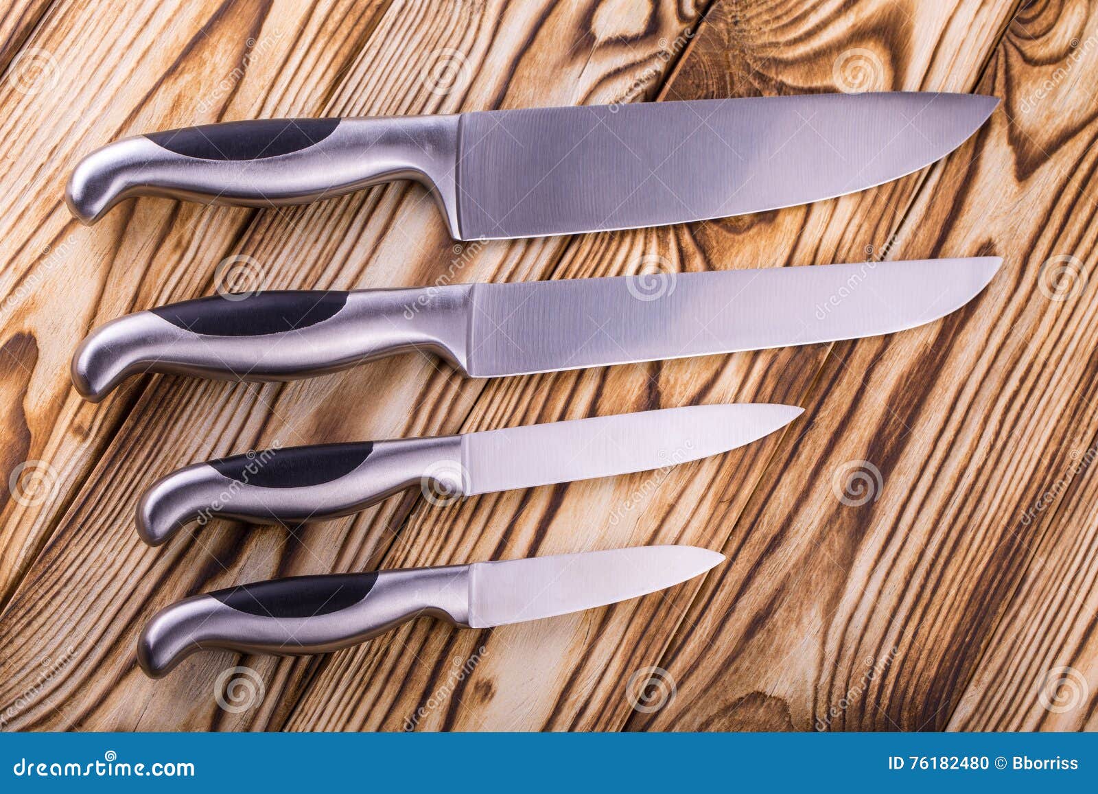 Set of Shiny Metal Kitchen Knives on a Wooden Table Stock Photo Image