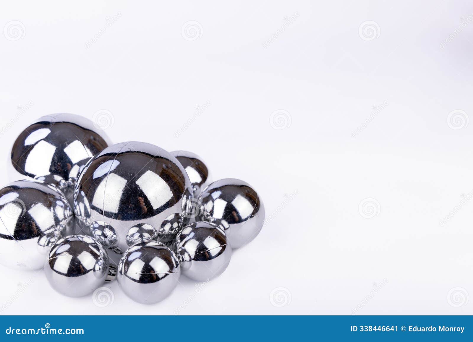 set of silver christmas balls in various sizes on a white background