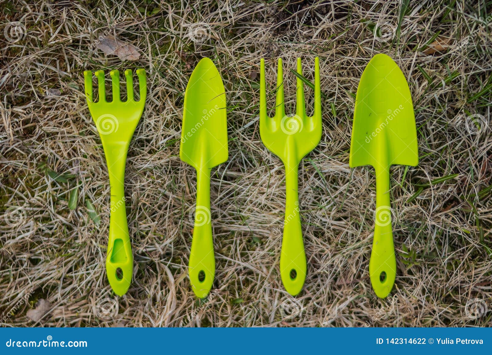 Set of Small Plastic Garden Implements Arranged in a Neat Row on a ...
