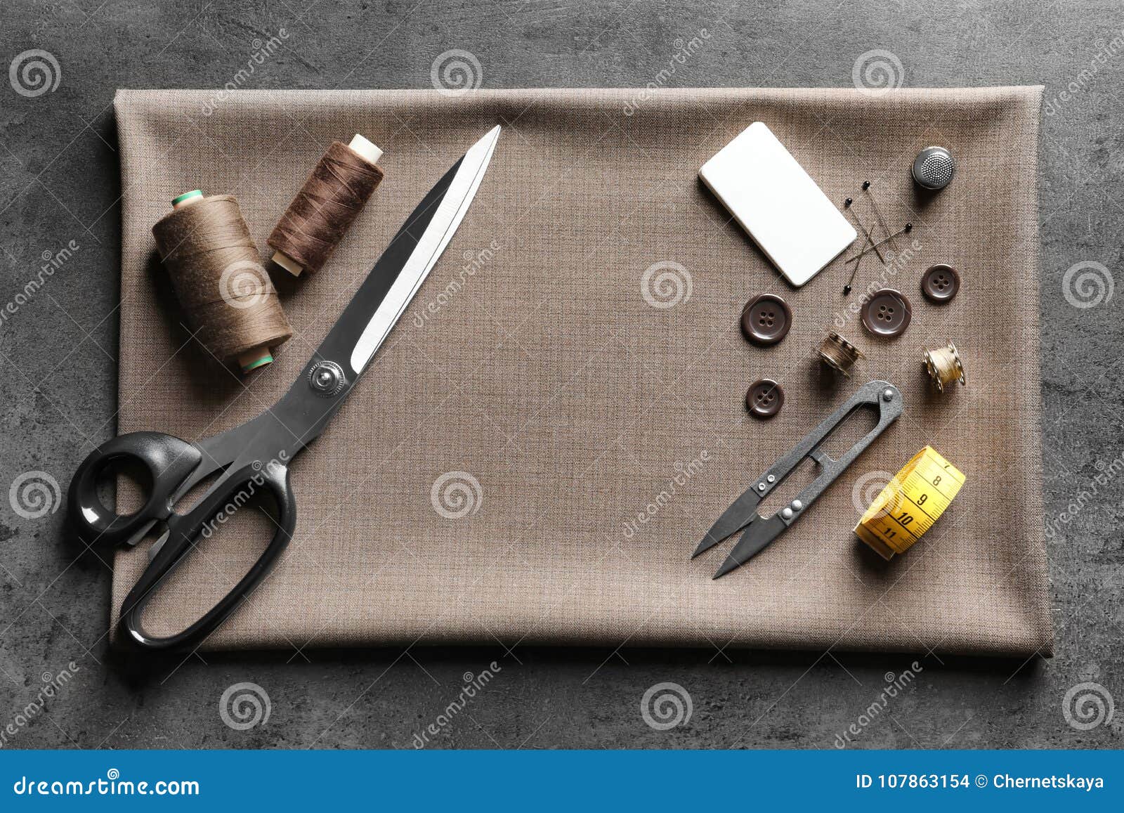 Set of Tailoring Tools, Accessories and Fabric on Table Stock Photo