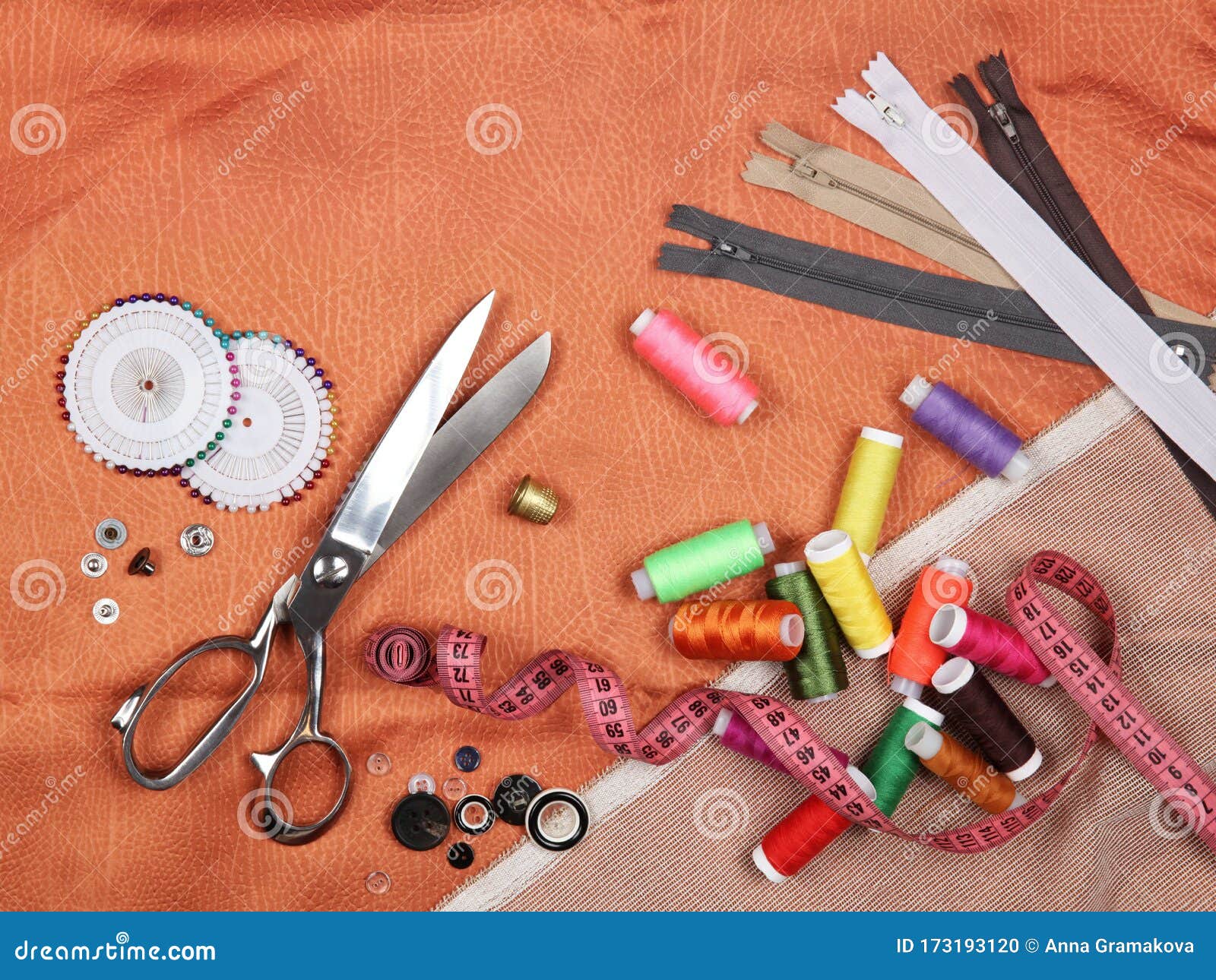 Set of Tailoring Tools and Accessories on Orange Fabric Stock Photo