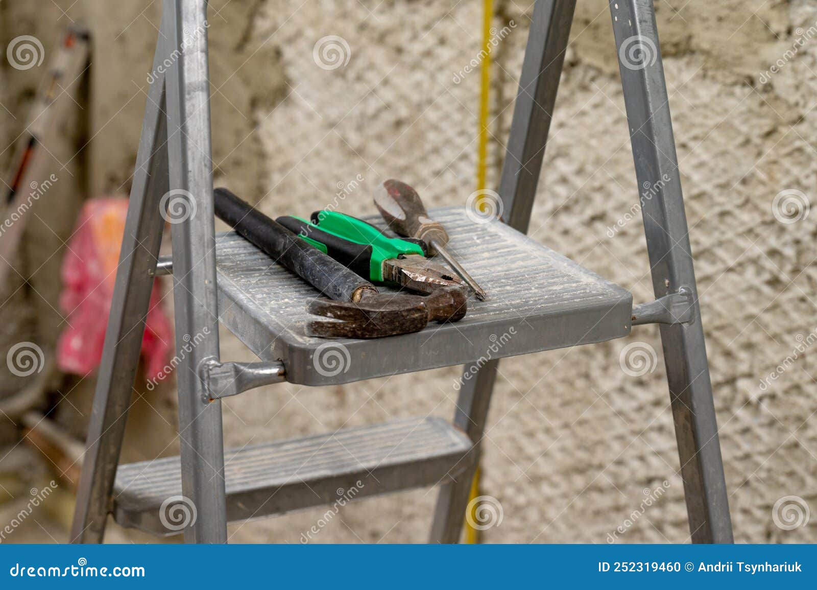Set of Three Construction Tools on a Ladder Hammer, Pliers and ...