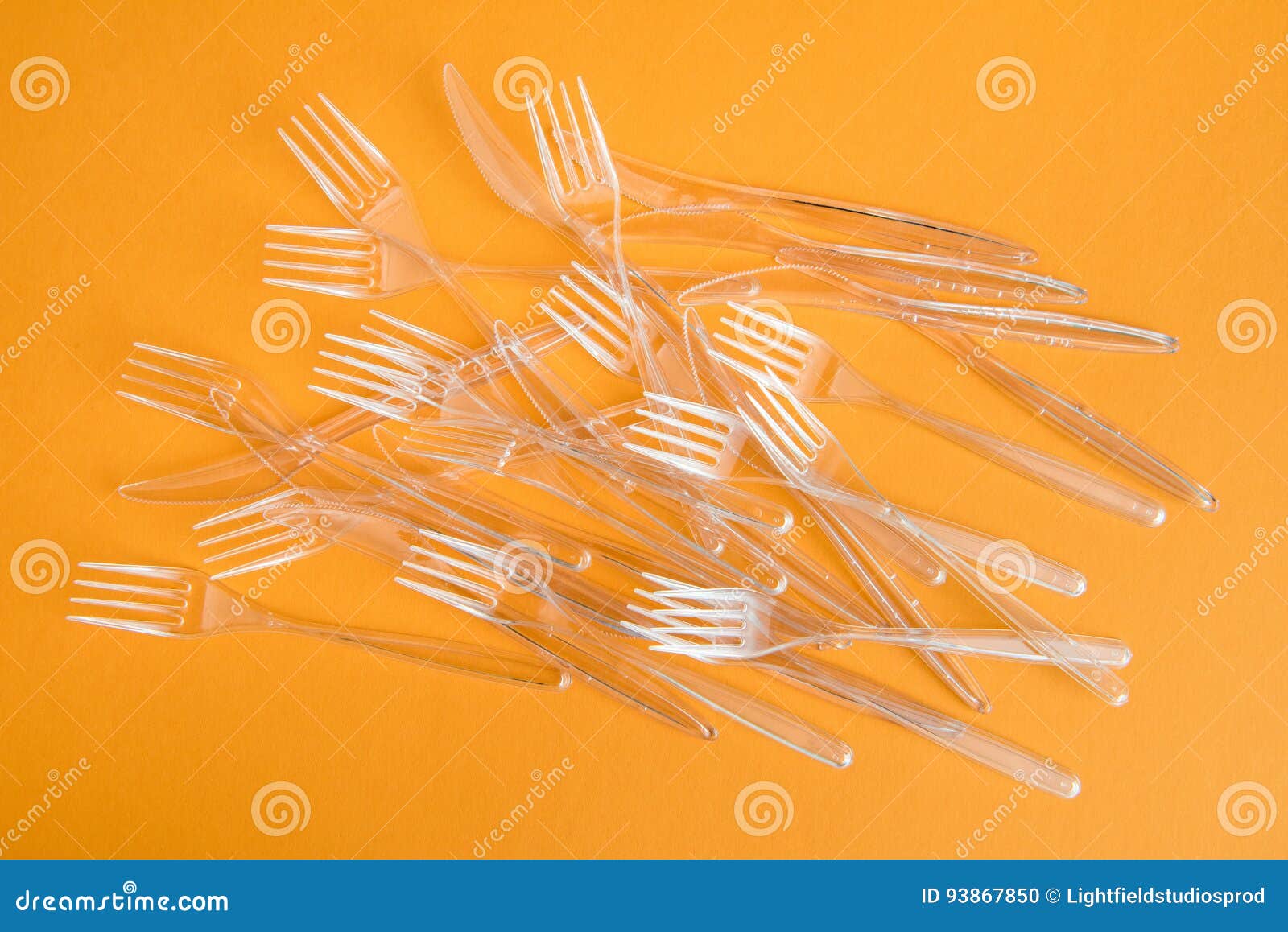 Set of Various Plastic Cutlery Isolated on Orange Stock Photo Image
