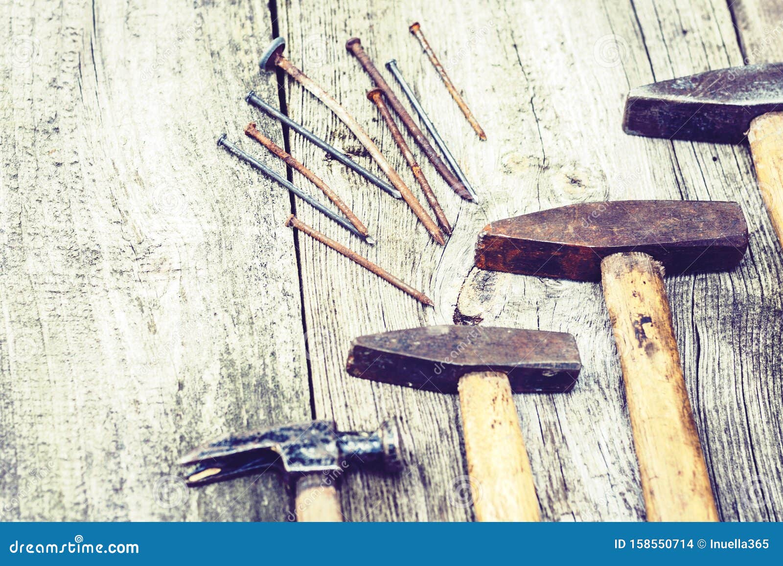 Set of Vintage Hand Construction Tools Hammers with Nails on a Wooden