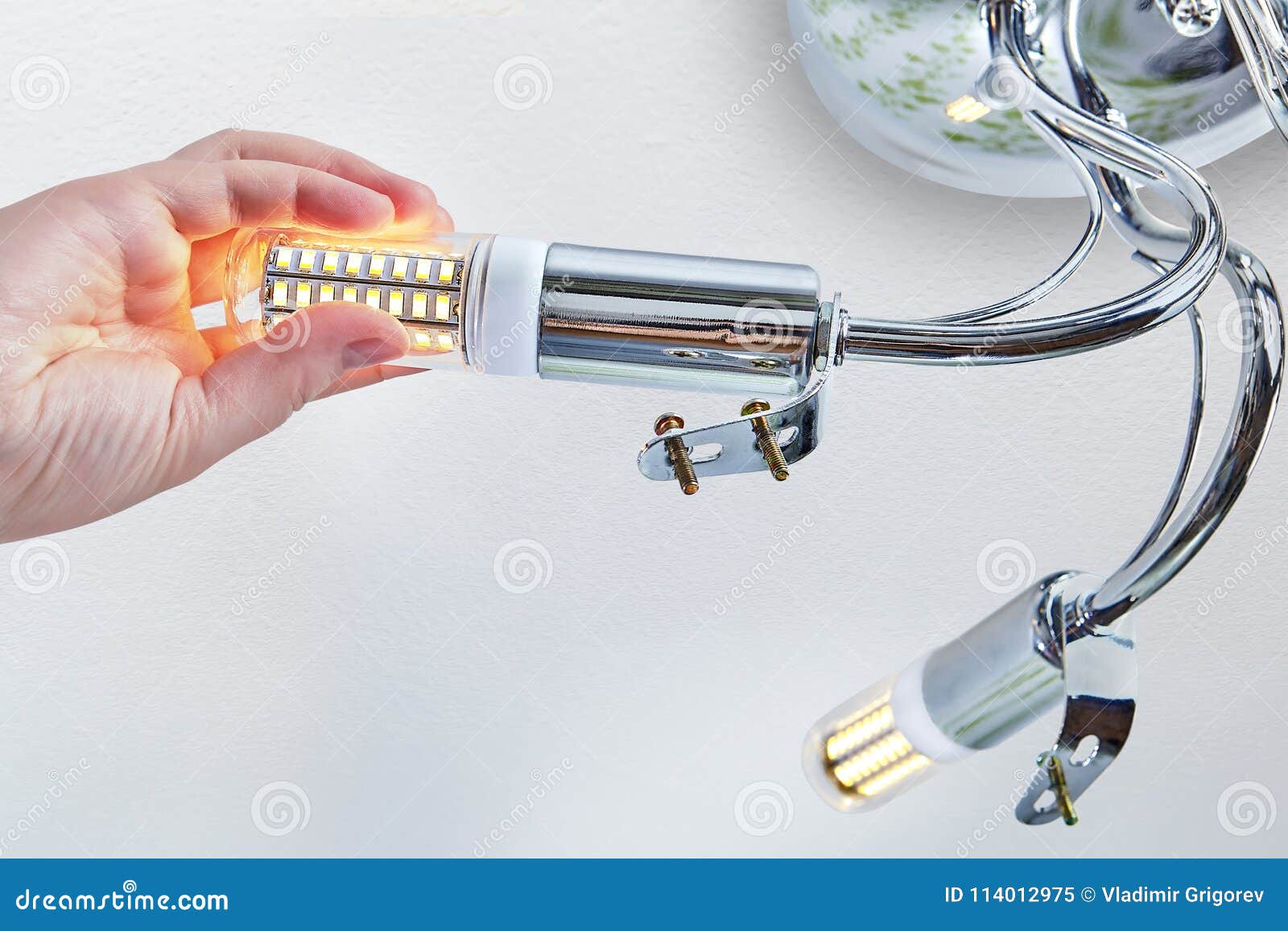 Hand Is Screwing Led Corn Lamp Into Room Ceiling Lighting