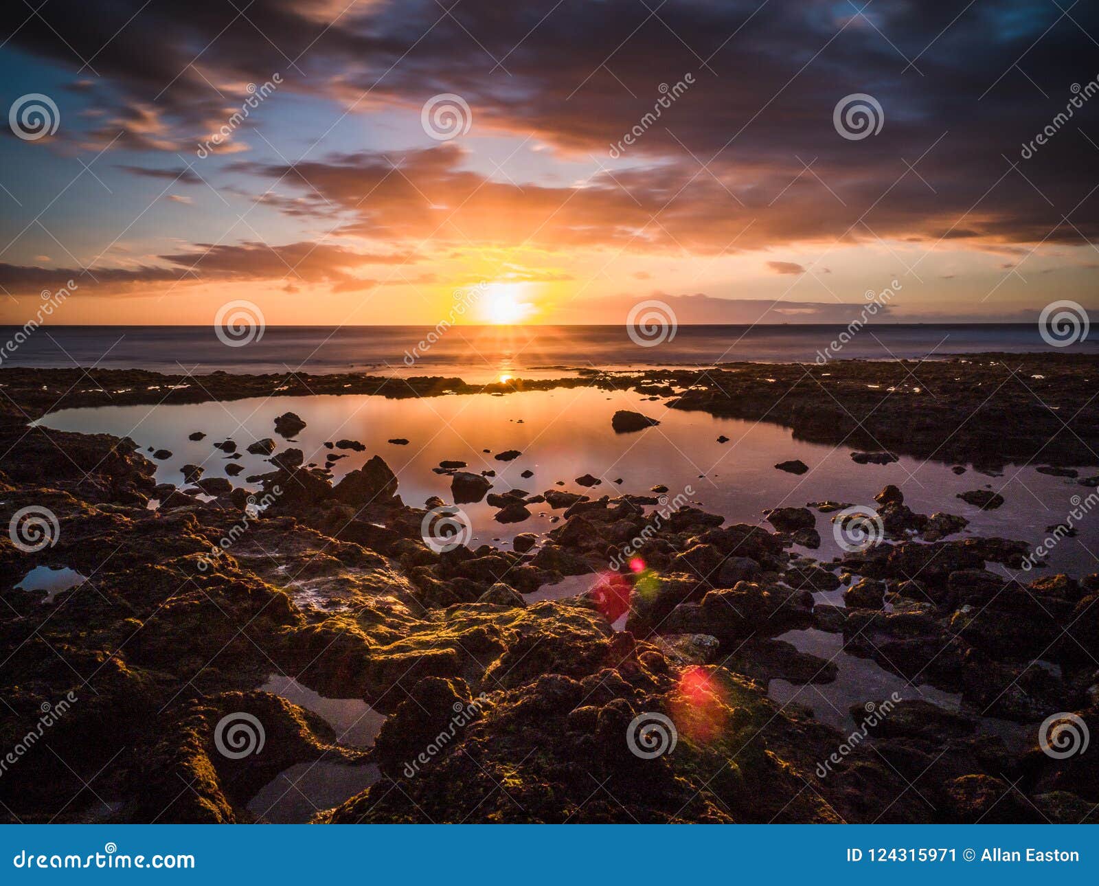 setting sun on the horizon off the coast of the spanish island of tenerife.