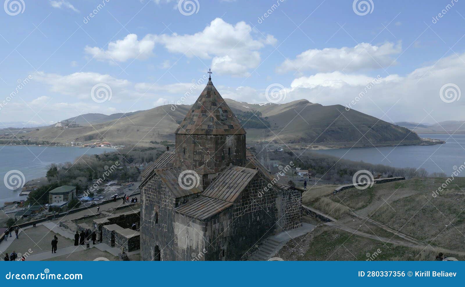 Sevan Monastery. Buildings, Lake Sevan, Mountains, Rocks, Grass, Sky