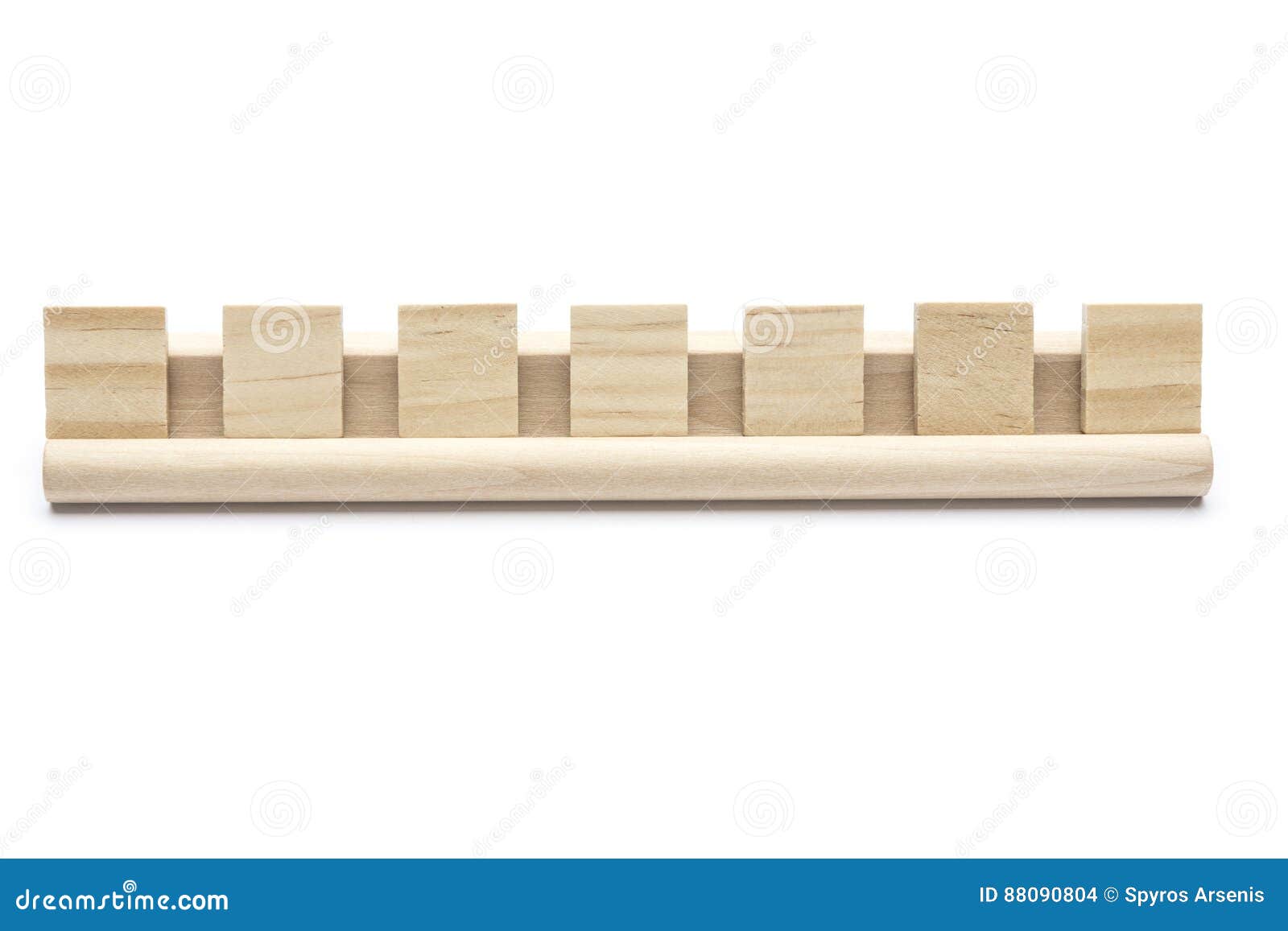 seven blank scrabble tiles on a wooden rack