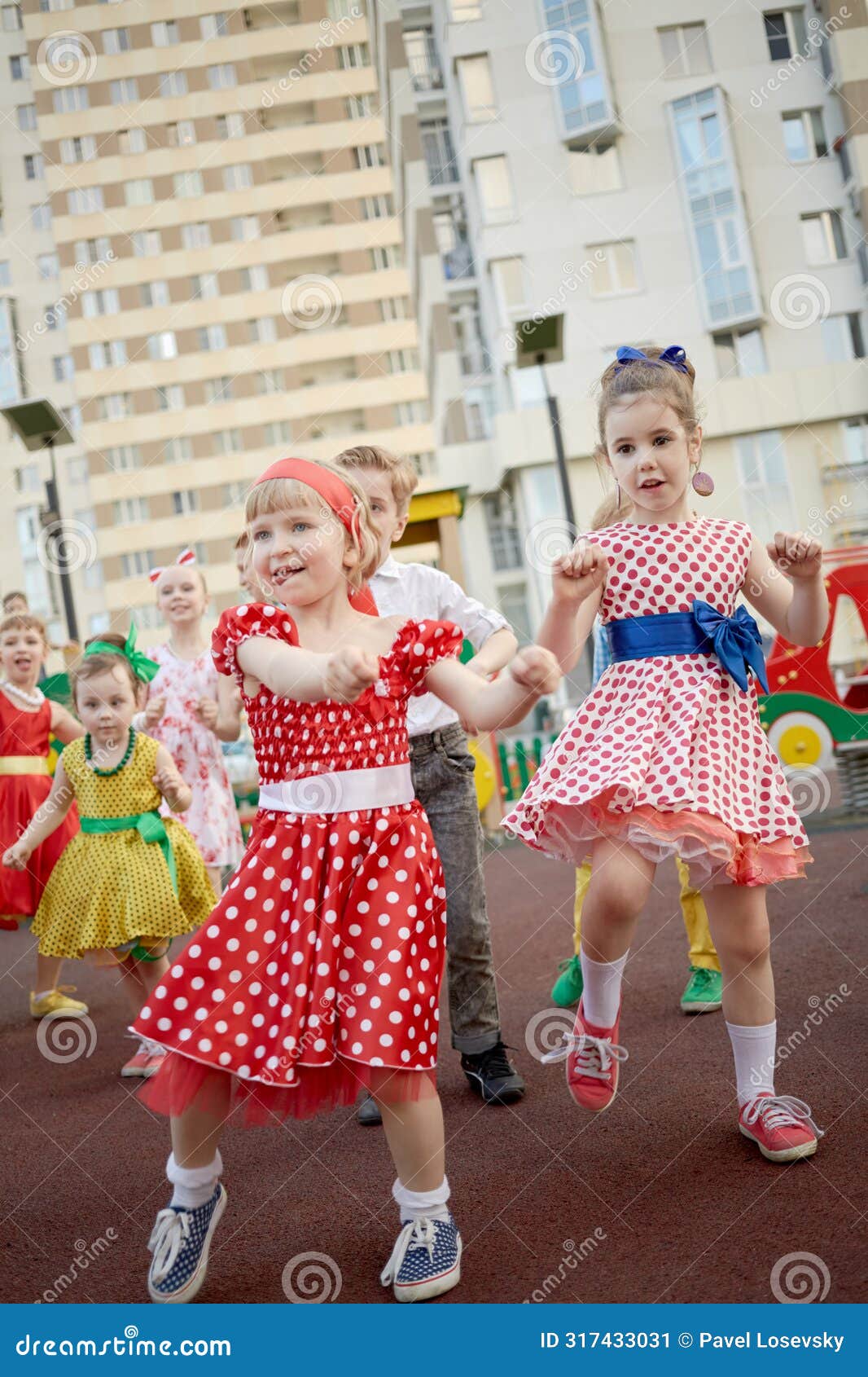 seven children dance at playground in