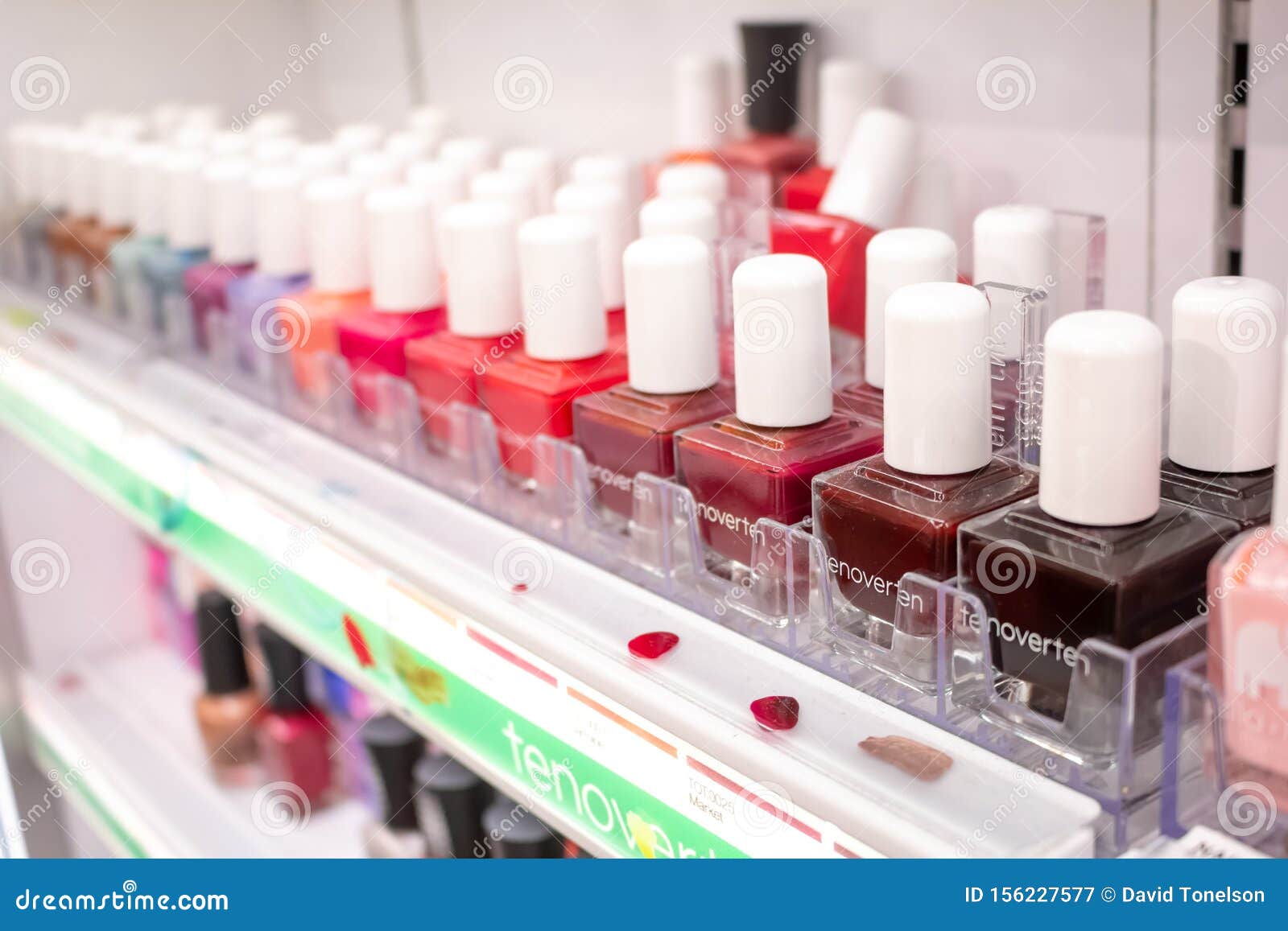 Nail polish samples on desk in beauty store Stock Photo by leszekglasner