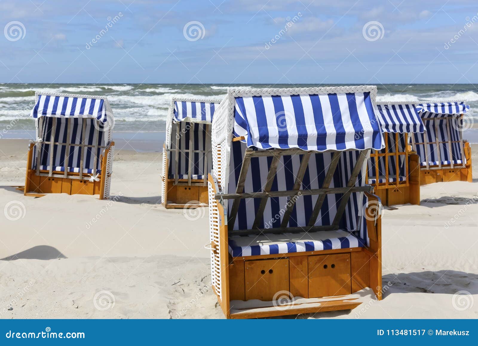 several canopied beach chairs by a sea coast