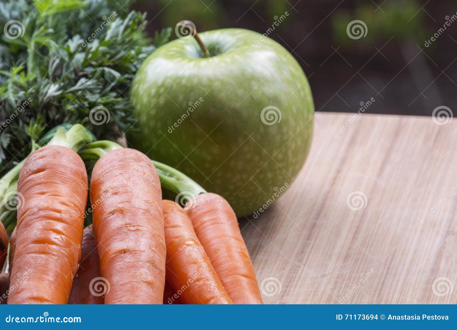 Several Carrots with an Apple on the Wood Stock Photo Image of