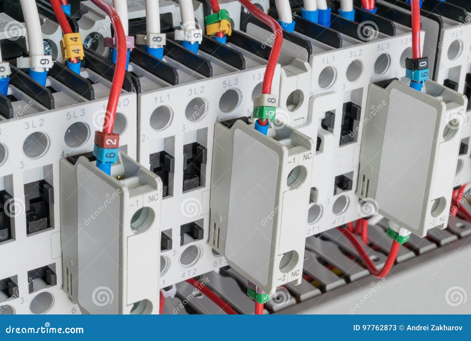 Several Contactors Arranged in a Row in an Electrical Closet. Stock