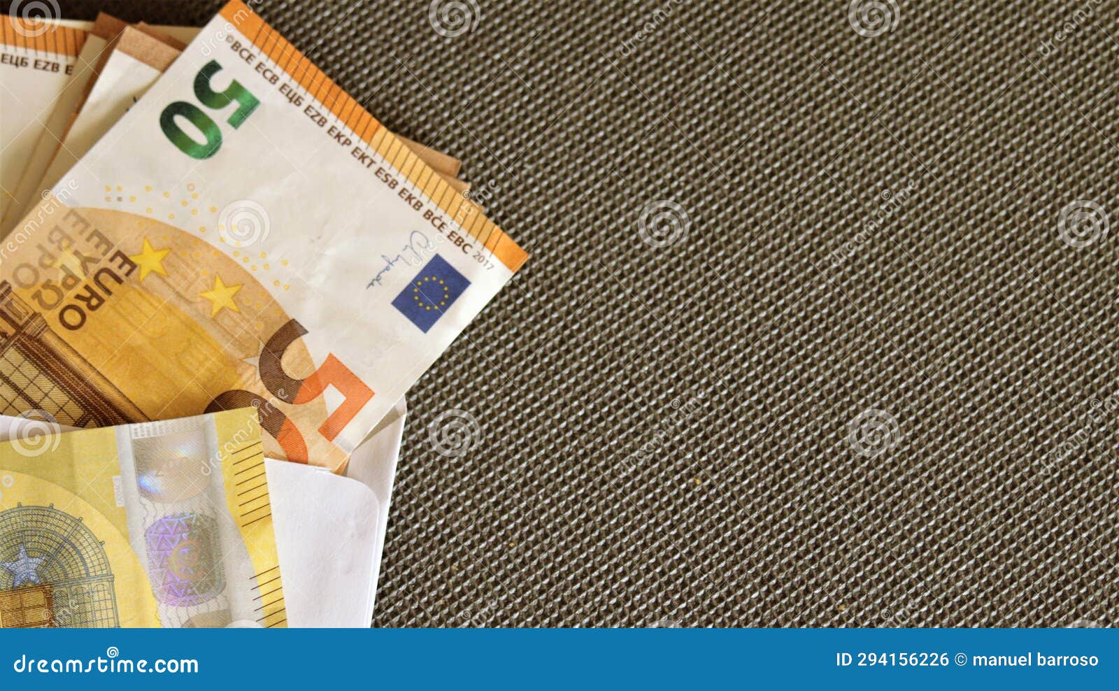 several fifty-euro notes on a black background.