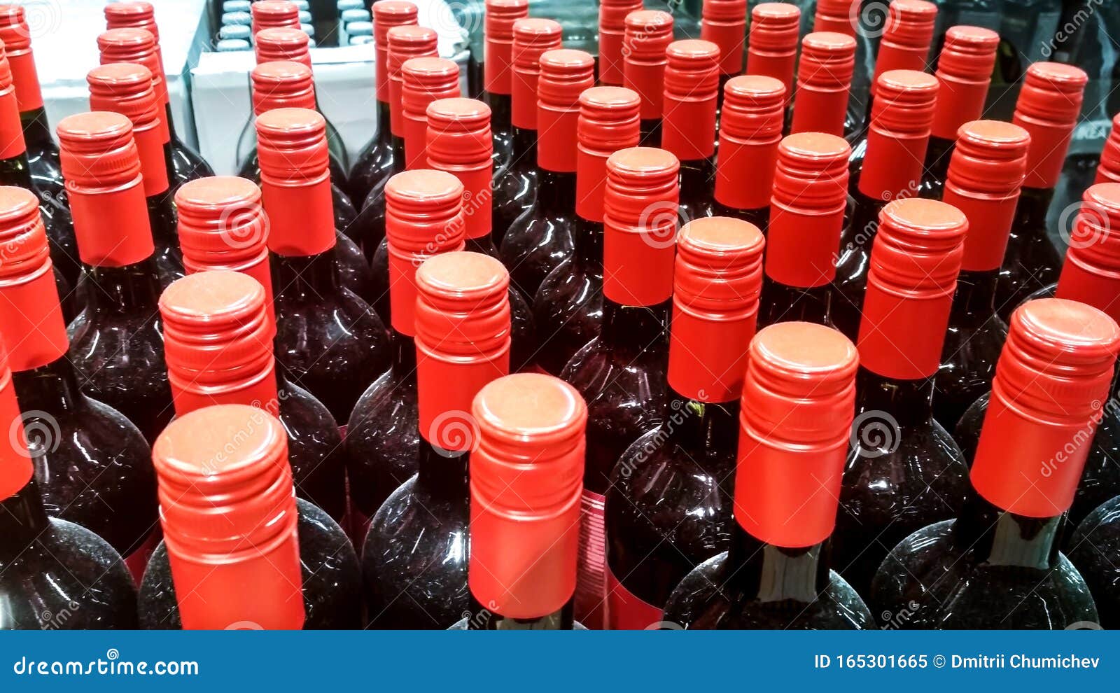 Several Glass Bottles with Red Caps in the Store Warehouse Stock Image