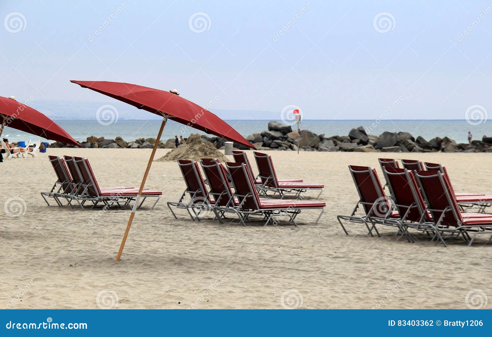 Several Lounge Chairs and Umbrellas Set at the Beach Stock Photo