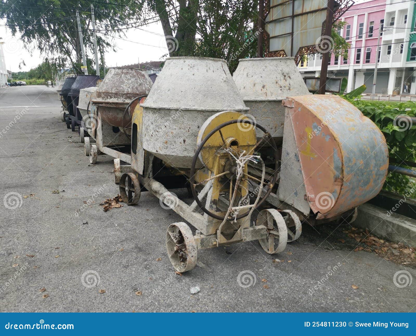 Several Old Cement Mixer Machines Left by the Roadside. Stock Photo