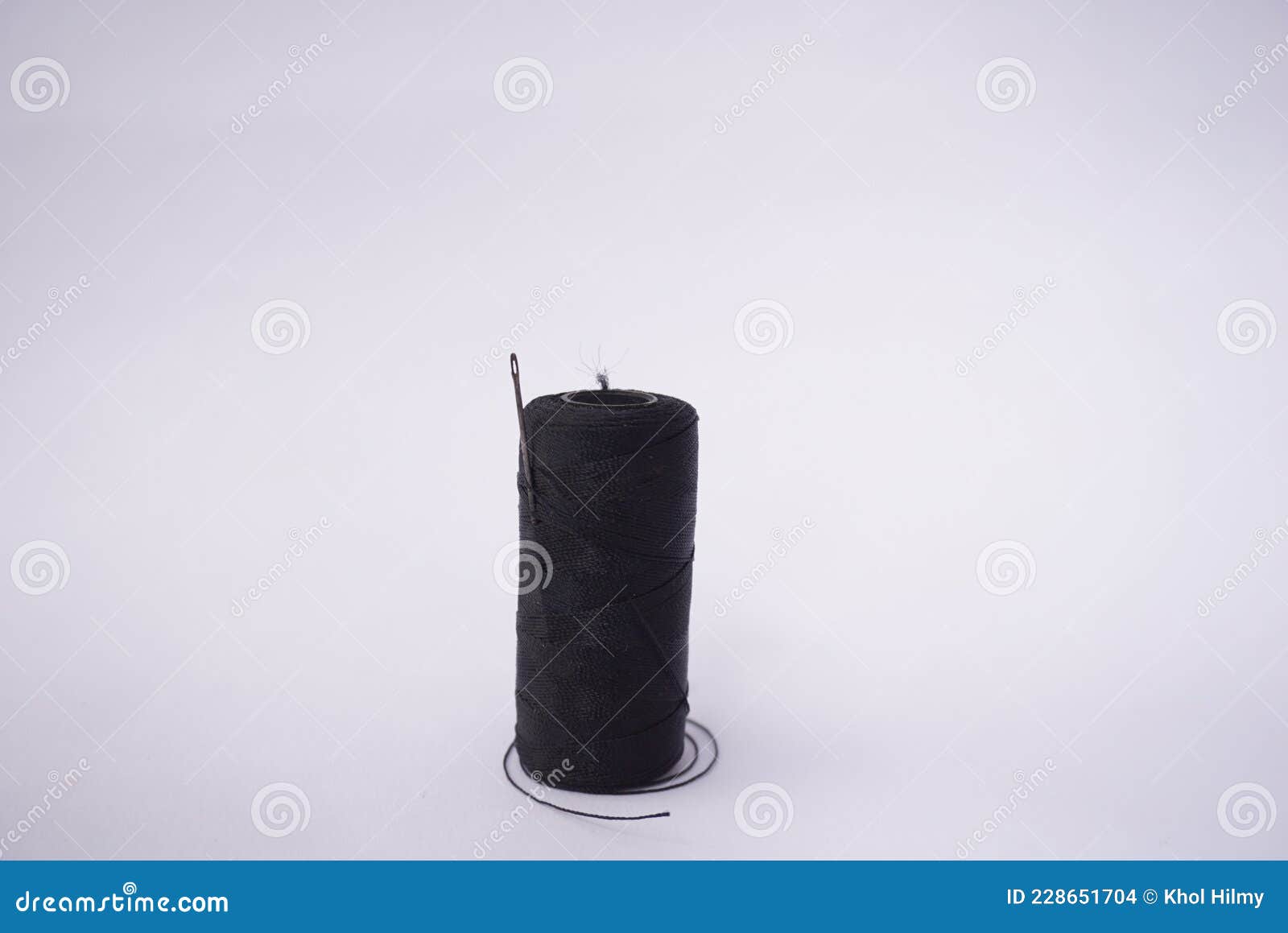 Several Piles of Sewing Thread Spools of Various Colors Isolated on a