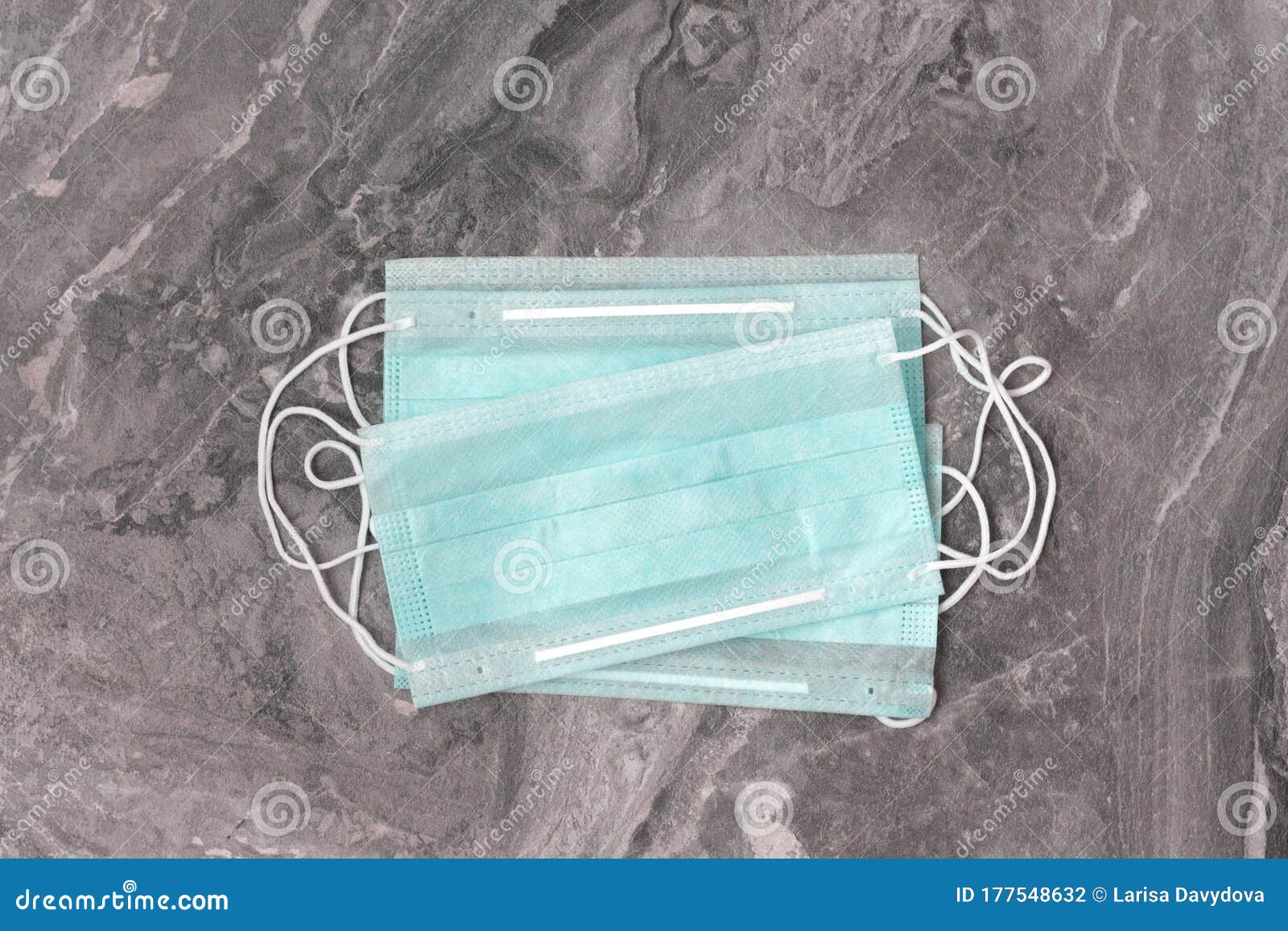several protective medical green masks against ncov-19 coronavirus on a gray background. serves to prevent an epidemic.
