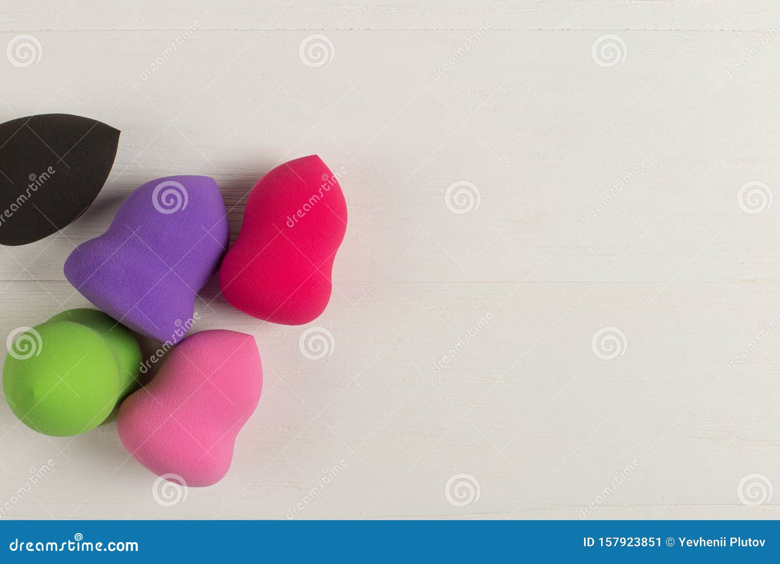 several sponges, a beautiful blender, lie on a wooden table. copy space