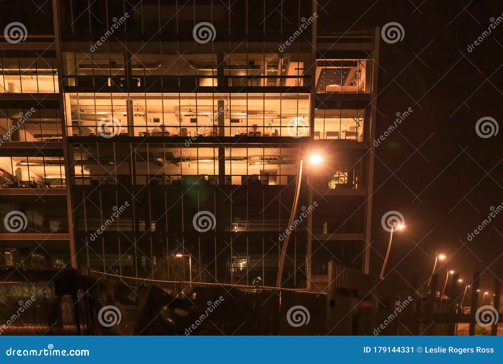 several stories of windowed office building lit