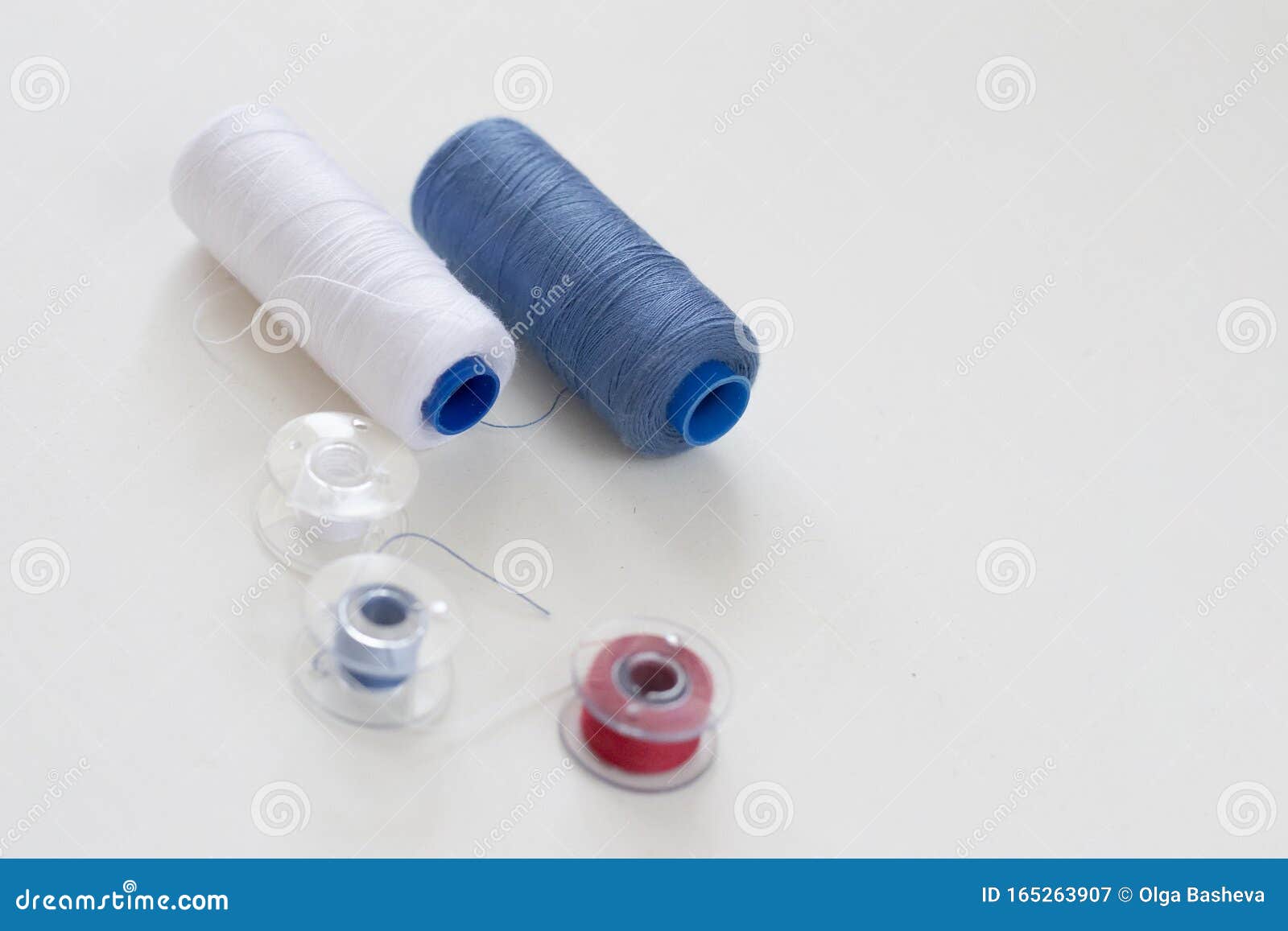 Sewing Accessories on a Light Background Closeup. Multicolored Spools