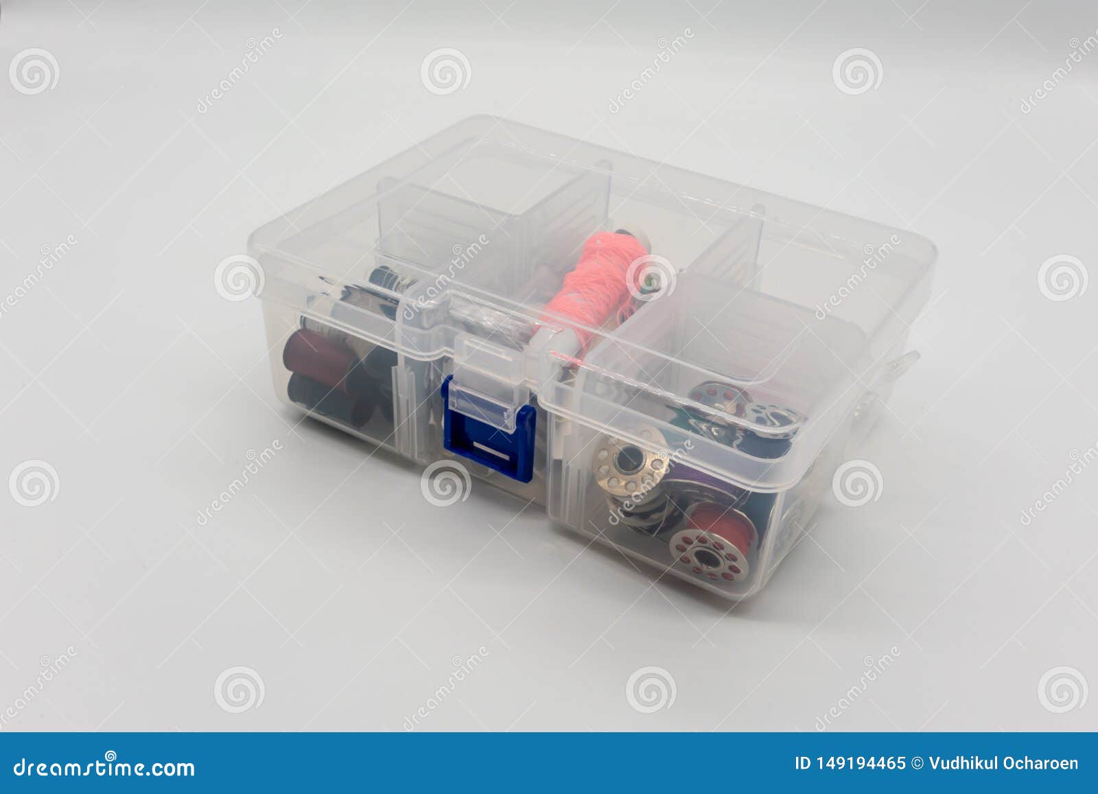 Sewing Accessories and Threads in the Clear Plastic Box on White Stock