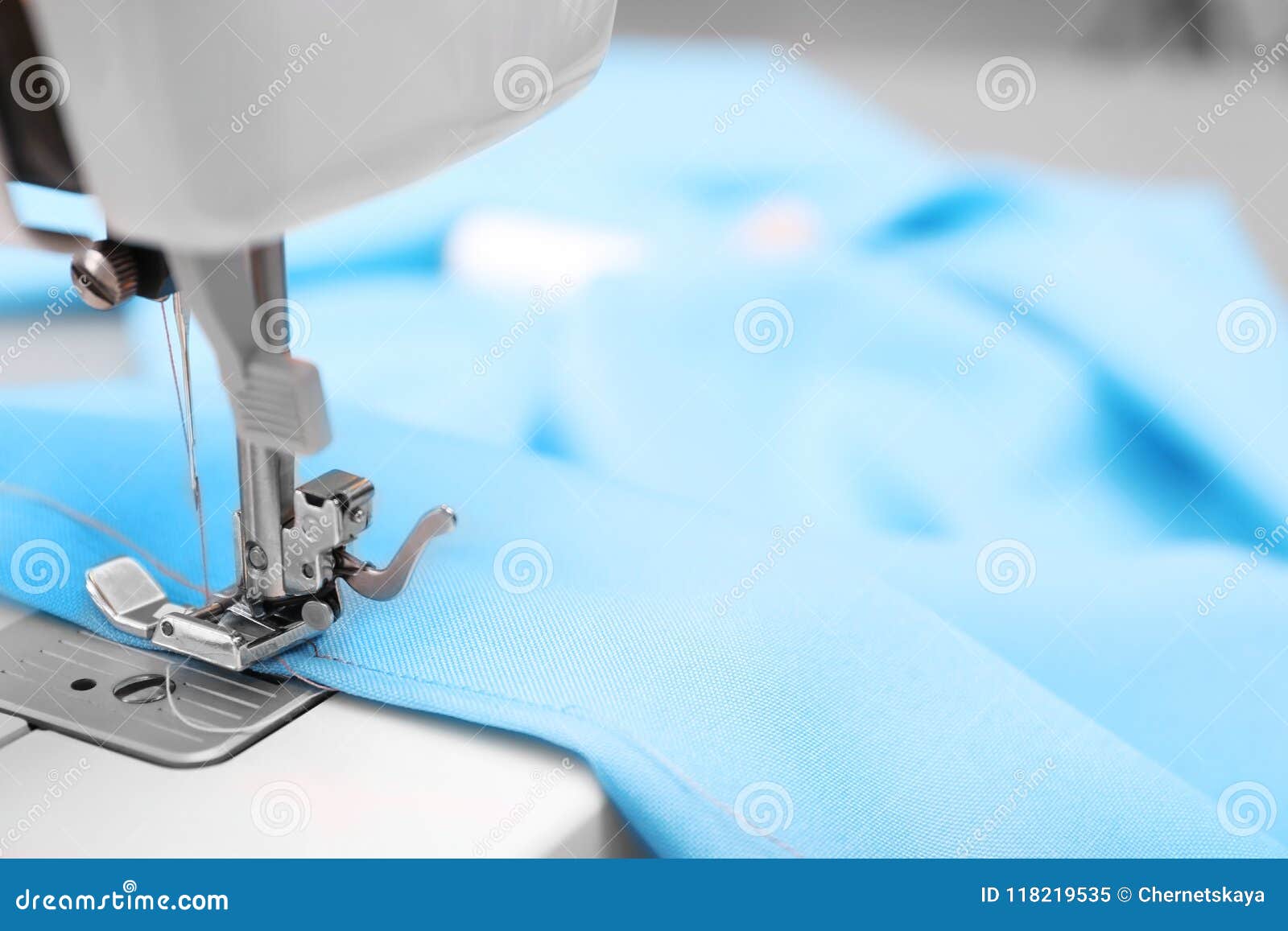Sewing Machine with Fabric on Table in Tailor Stock Image