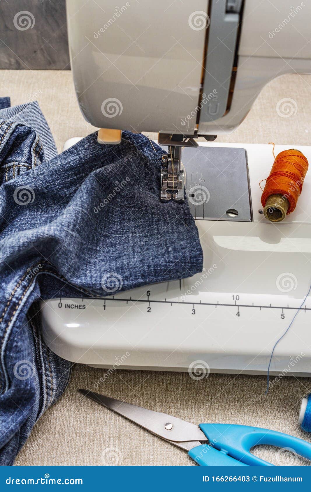 Sewing Machine Foot on Denim. Scissors, Spools of Thread Stock Image