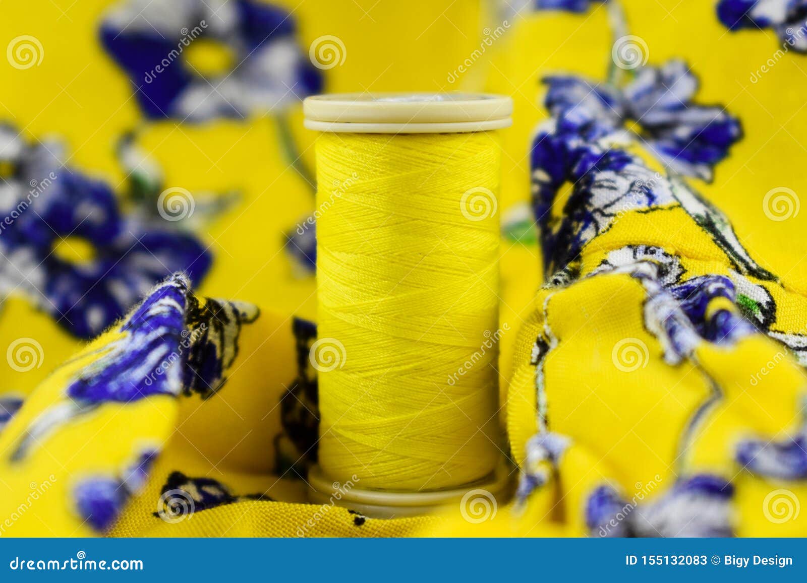 Sewing Thread. Yellow Color. with Yellow Flowers on Fabric. Stock Image
