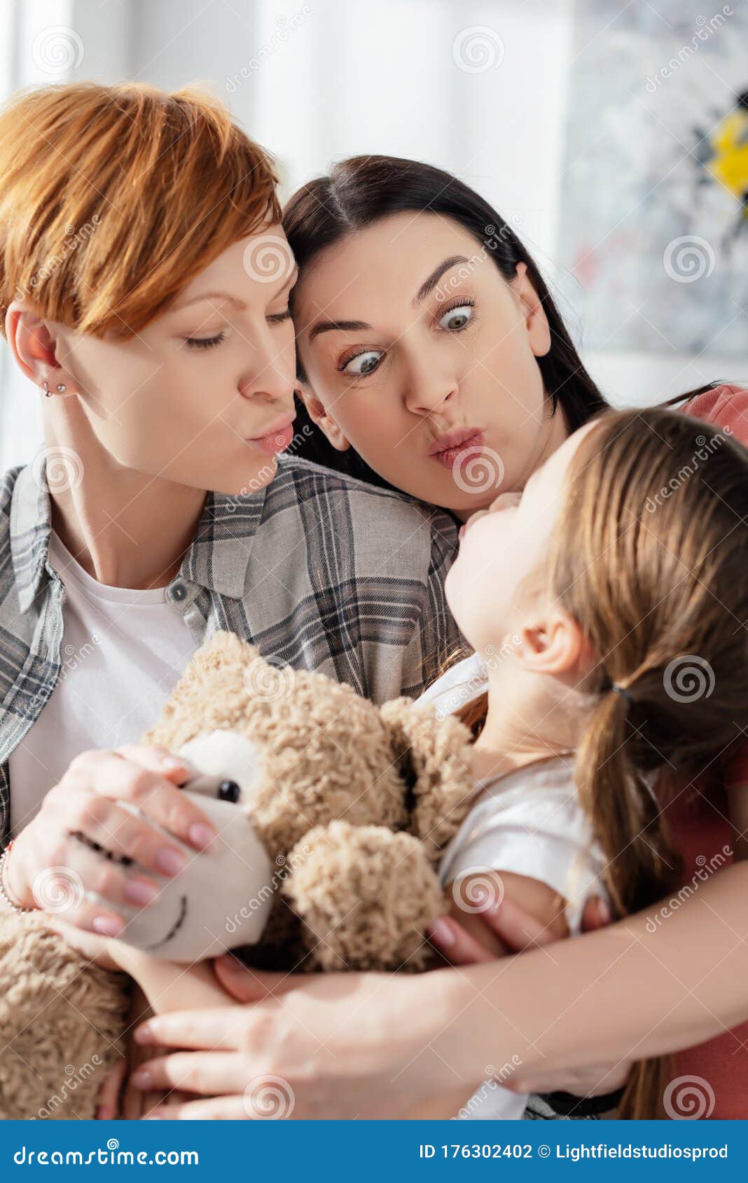 Sex Parents Grimacing with Daughter Holding Stock Photo picture
