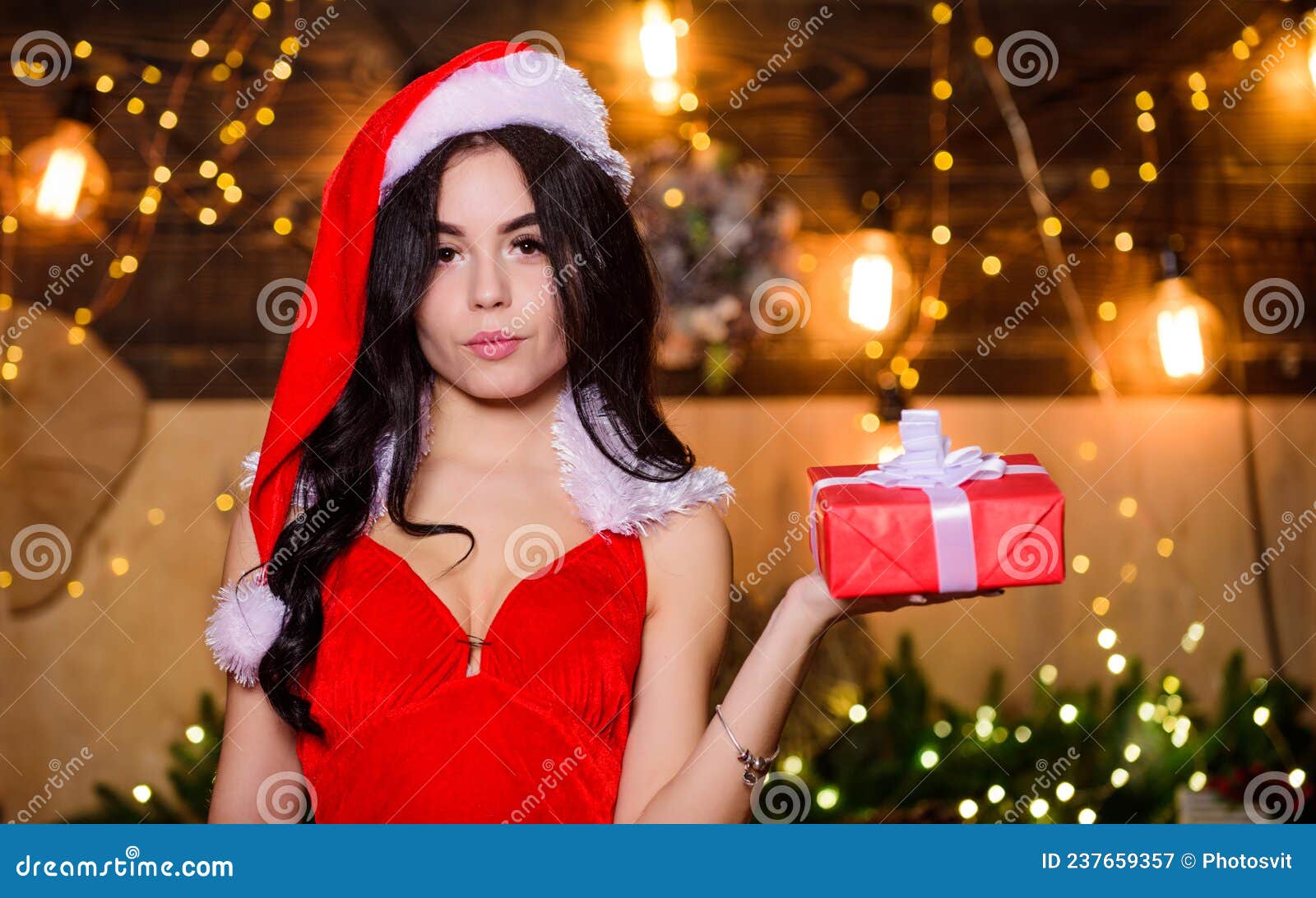 Sex Shop. Attractive Girl in Erotic Lingerie Hold Gift