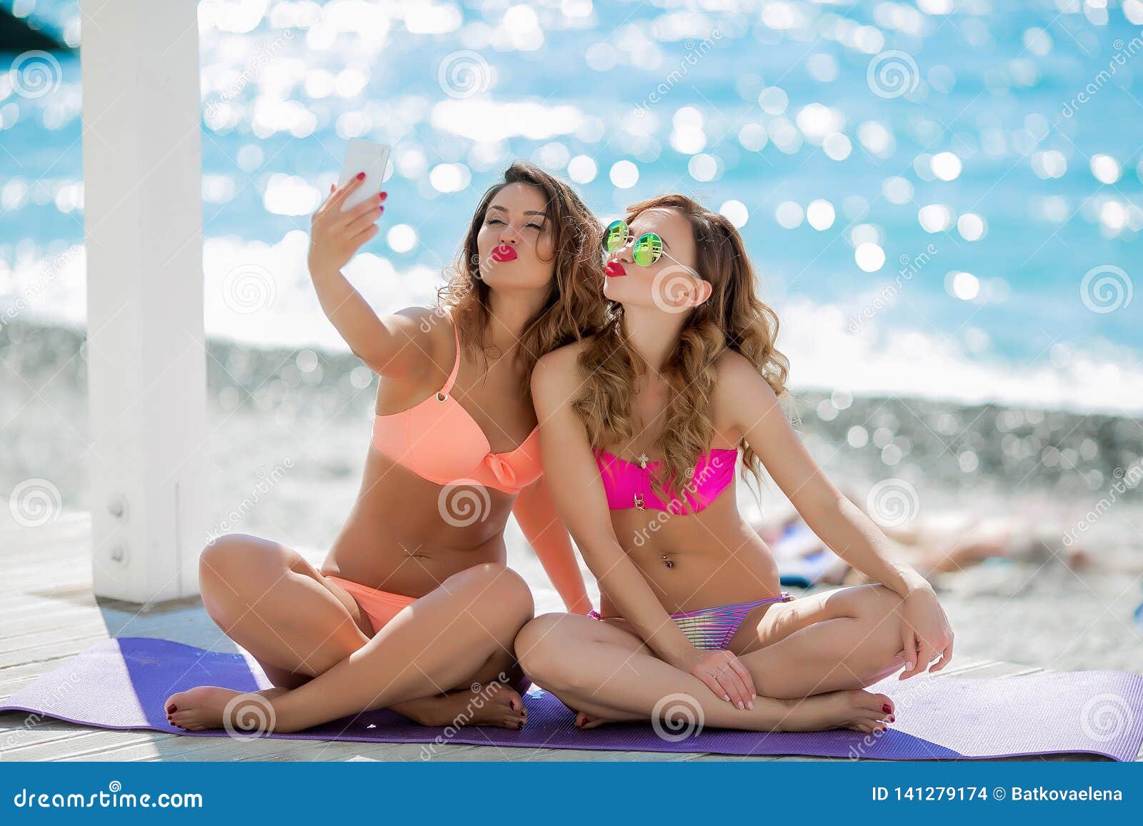 Sexual Girl in a Bright Bikini on a Sunny Beach