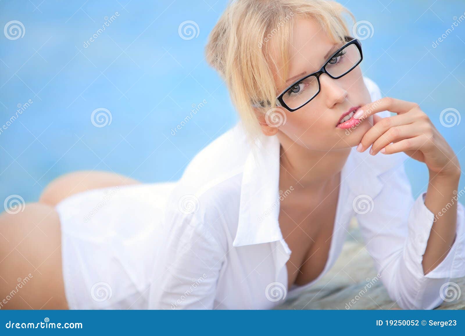 The sexual girle on the sea. The girl with glasses in a white shirt on the sea