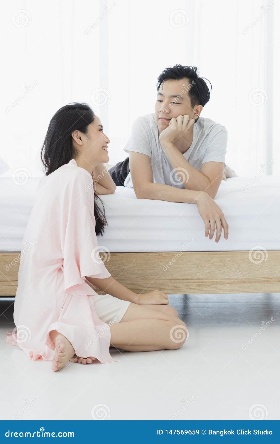 Asian Couple In Pajamas Sit In Bedroom Stock Image Image