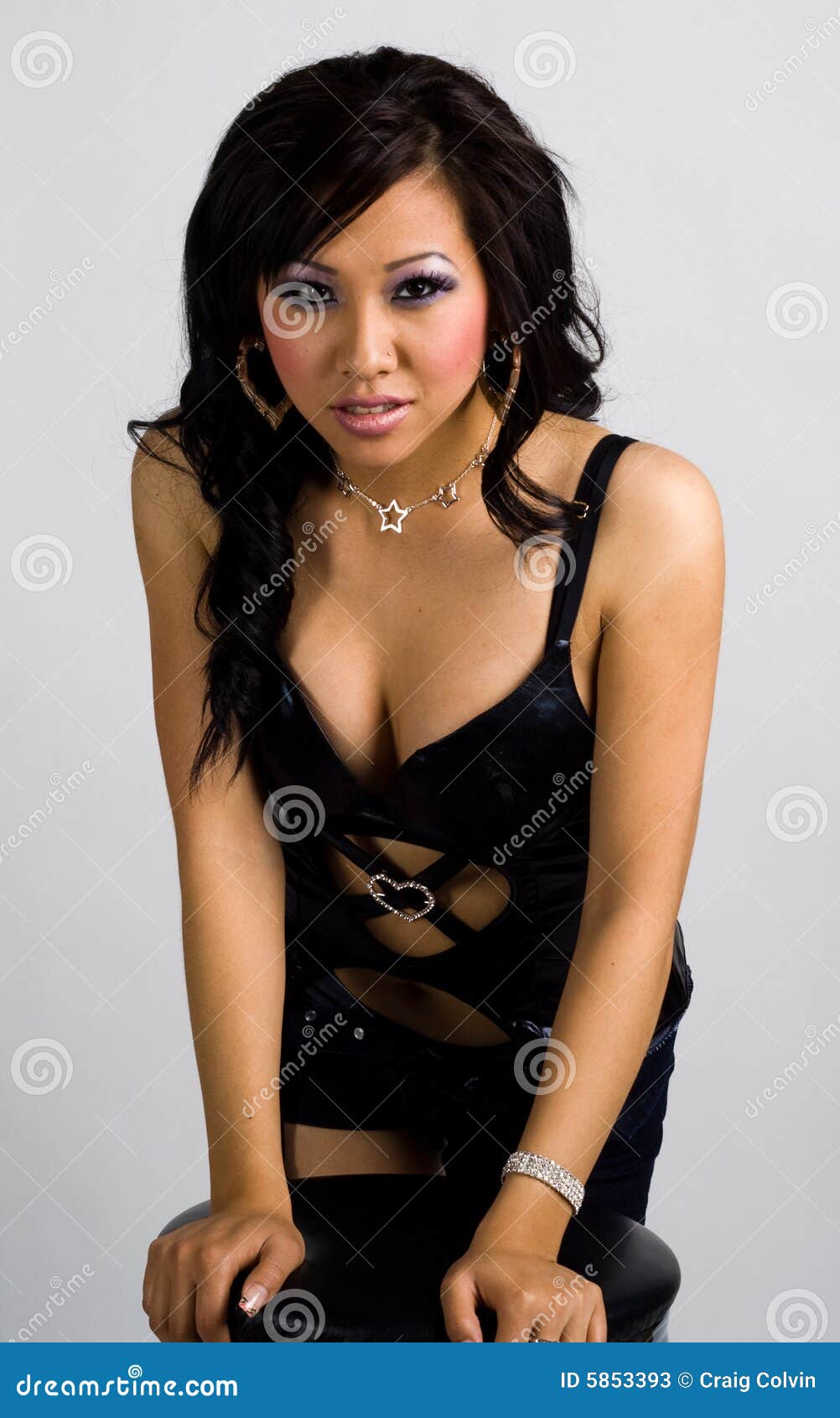 Asian Girl Leaning on a Bar Stool Stock Image