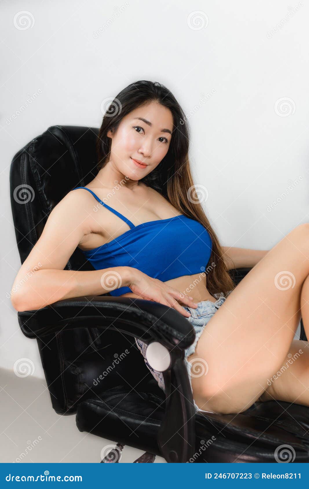 Asian Women Wearing a Blue Single-breasted Dress Sitting in a Chair Stock Image