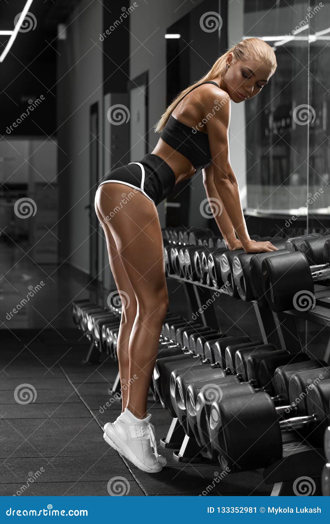 Athletic Girl Working Out in Gym. Fitness Woman Doing Exercise