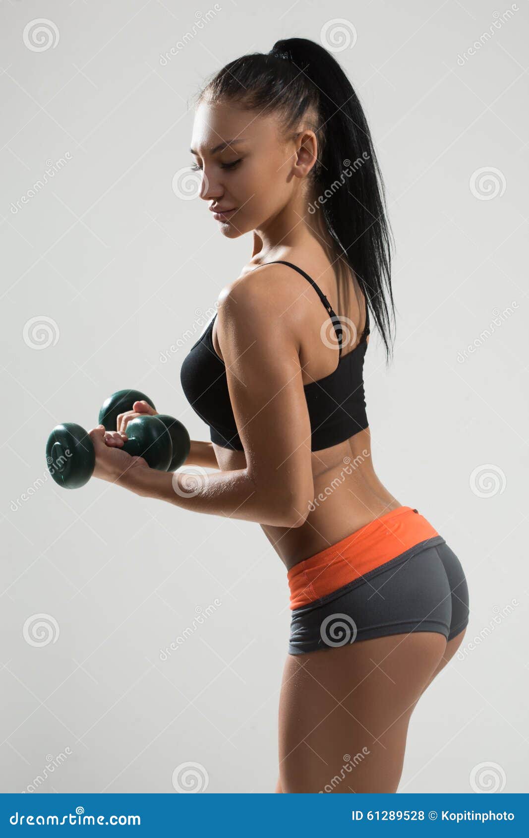 Sexy athletic girl working out in gym. Fitness woman doing exercise. Sexy  beautiful butt in thong Stock Photo