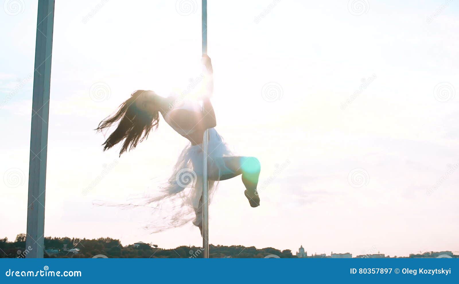 Attractive Girl Poledancer Performs Advanced Pole Dance Tricks at