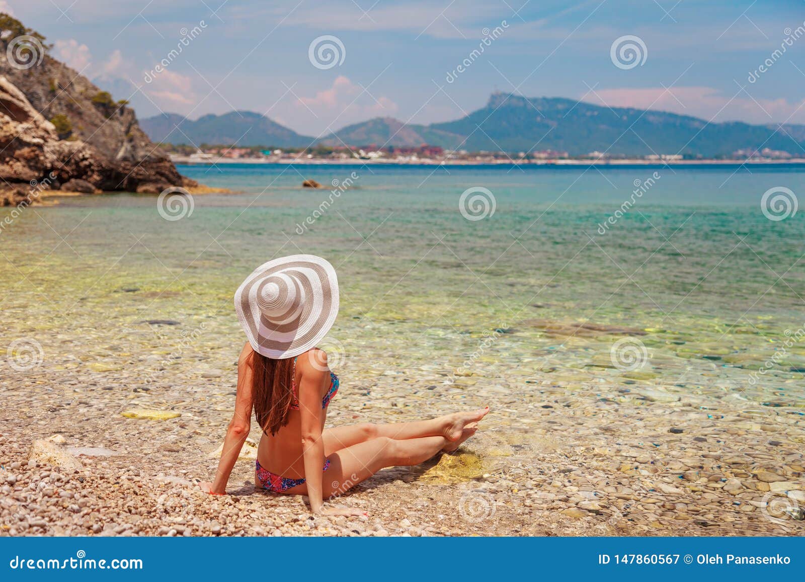 Back of Beautiful Woman in Bikini and Creative Hat on Sea Background