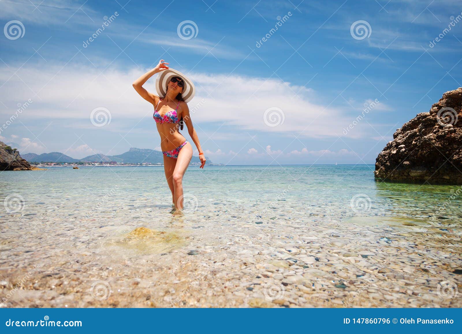 Back of Beautiful Woman in Bikini, Creative Hat and Sunglasses on Sea Background