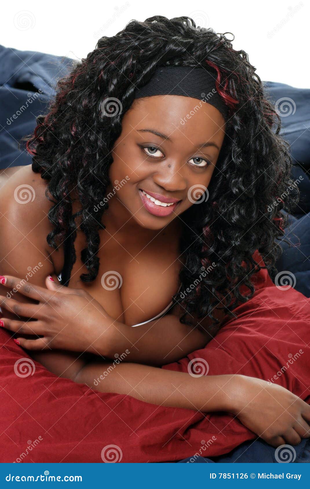 Black woman lying in bed stock photo photo