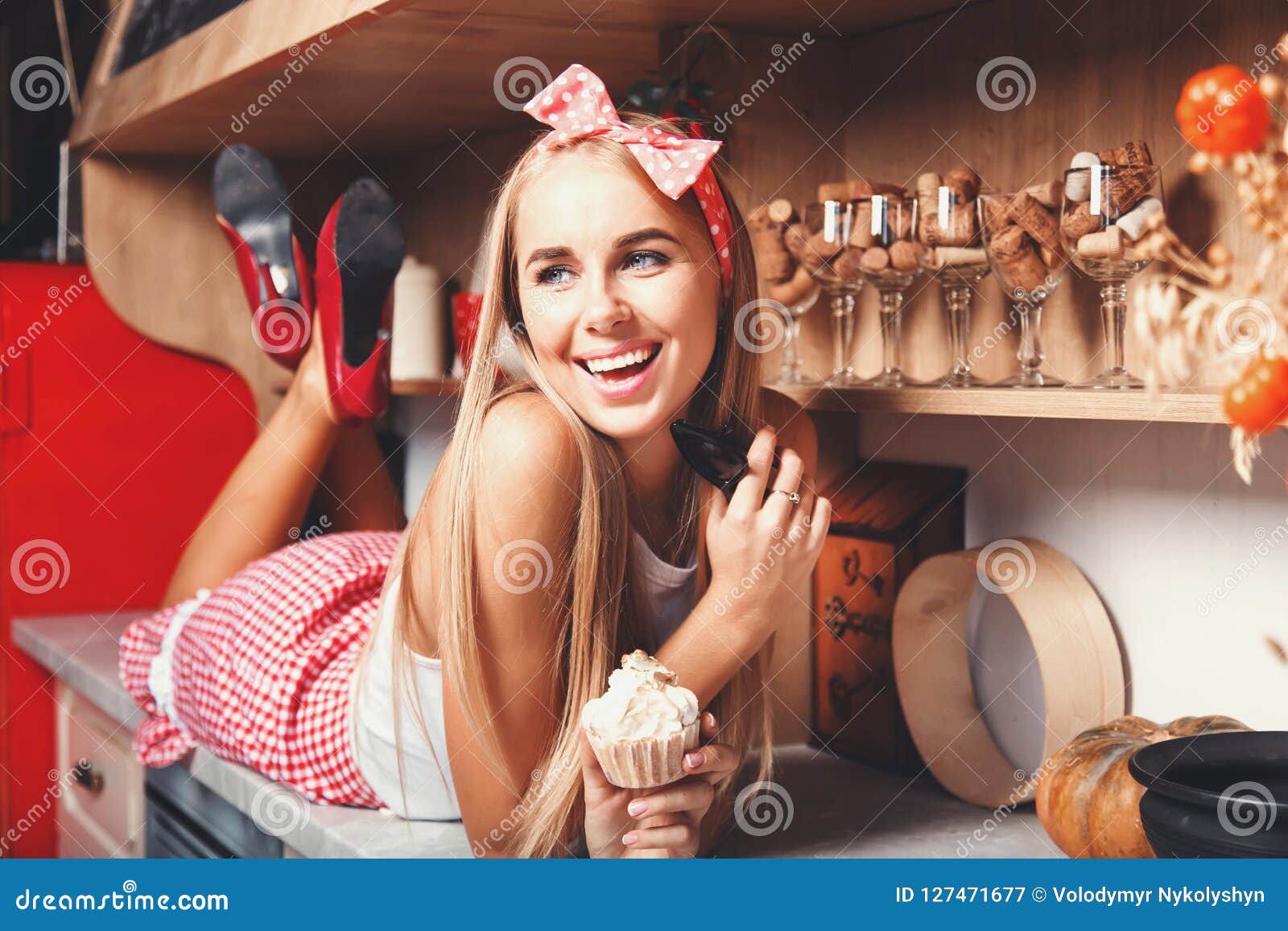 woman laying and smiling with cupcake