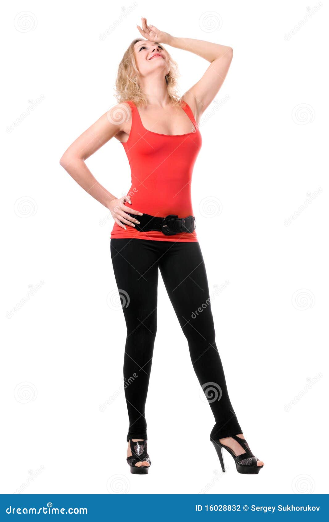 Foto Stock Side view of hot blonde in leggings and top looking at
