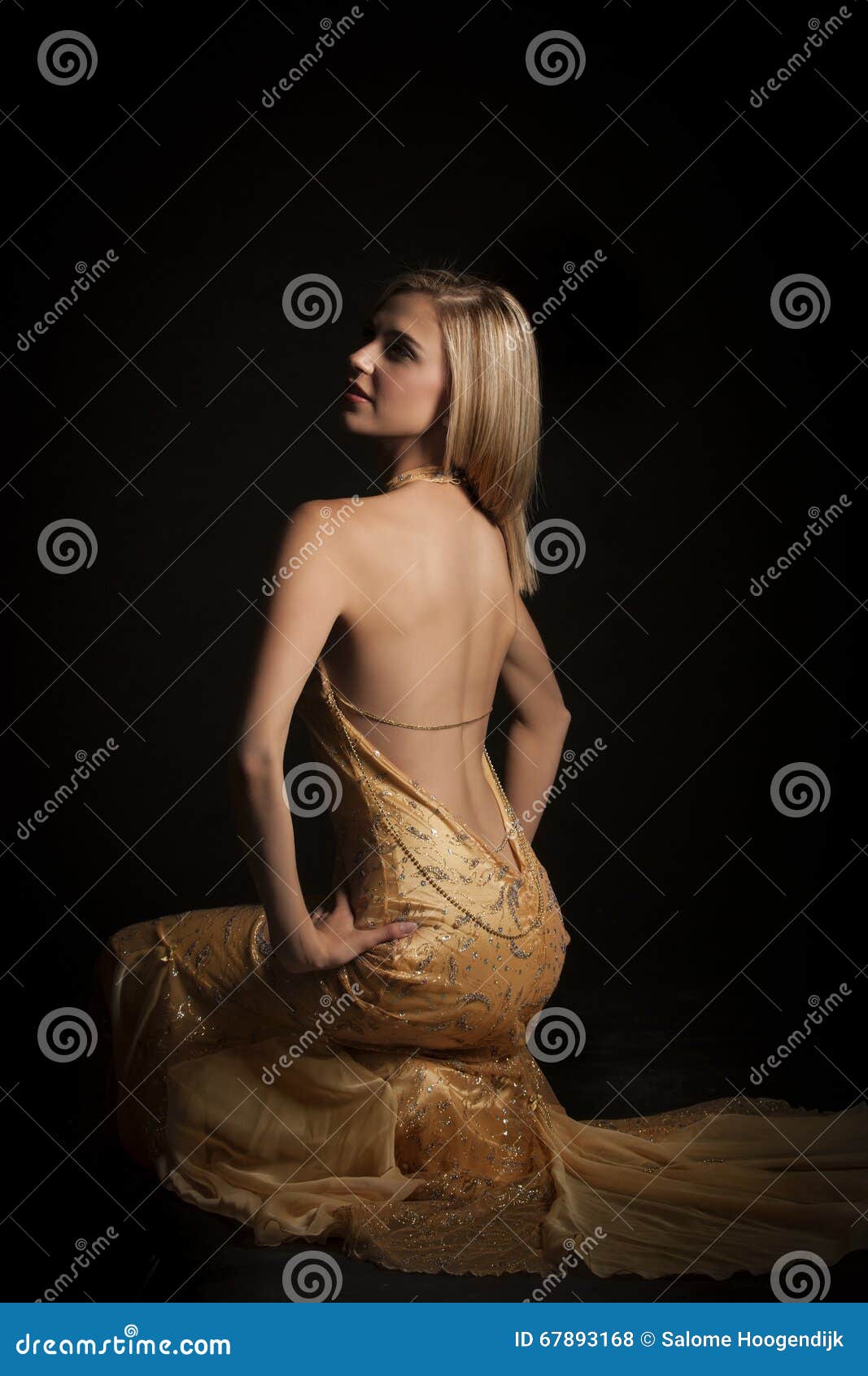 blonde woman in golden revealing evening dress