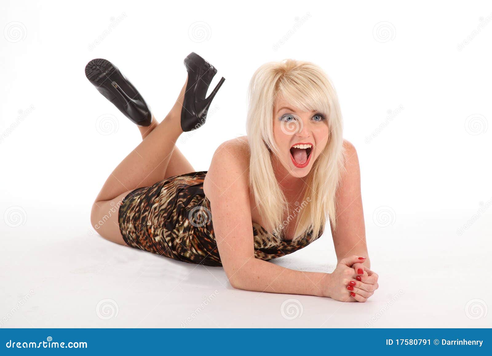 blonde woman lying on floor laughing