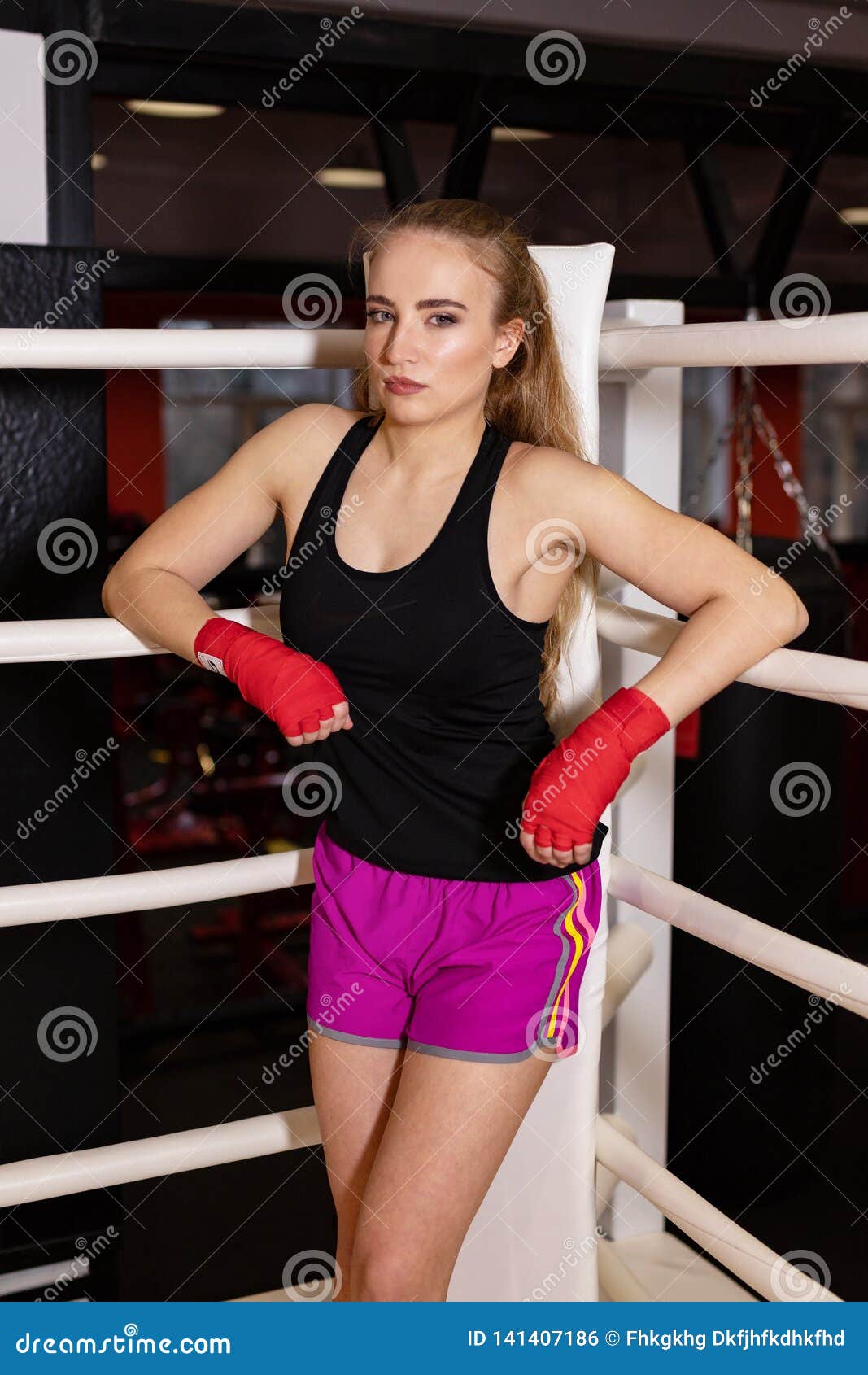 Boxing Girl Stands Leaned on Ropes of Competition Ring. Fashionable